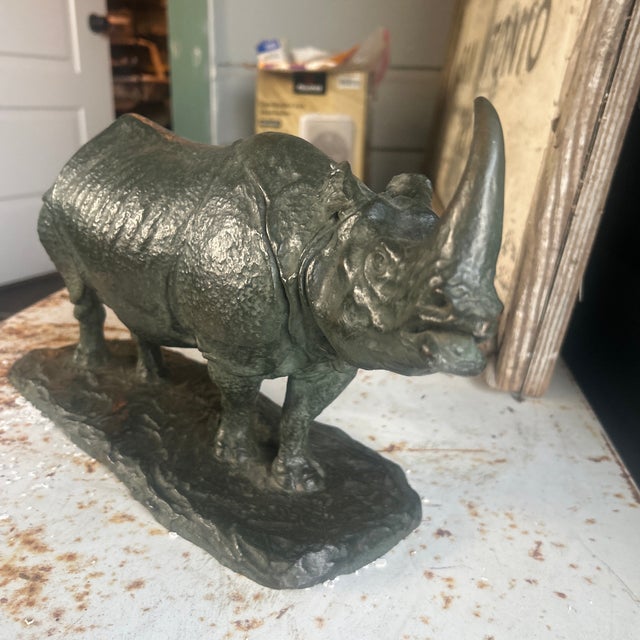 This bronze rhinoceros sculpture was created by R.H. Rockwell, an American sculptor known for his realistic wildlife...