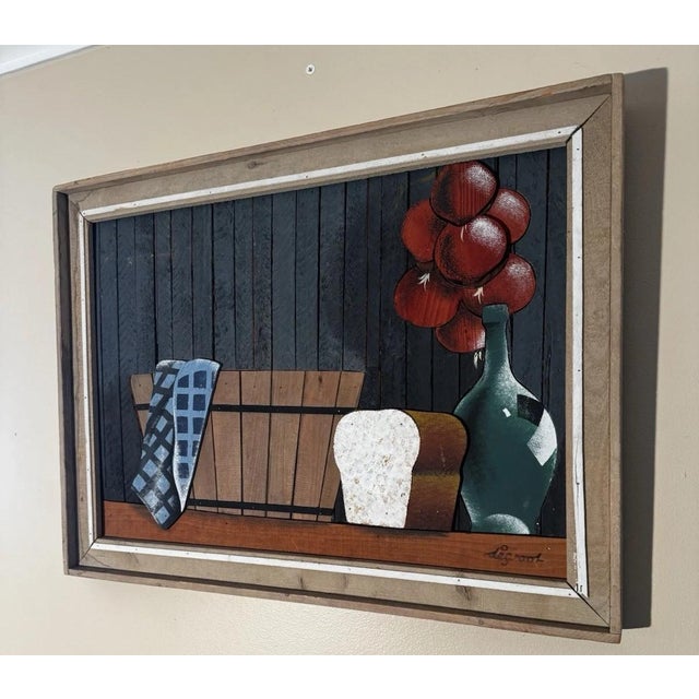 This folk art-style kitchen still life, lathe-art panel portrays cut-out painted wood elements affixed to a dark wood...