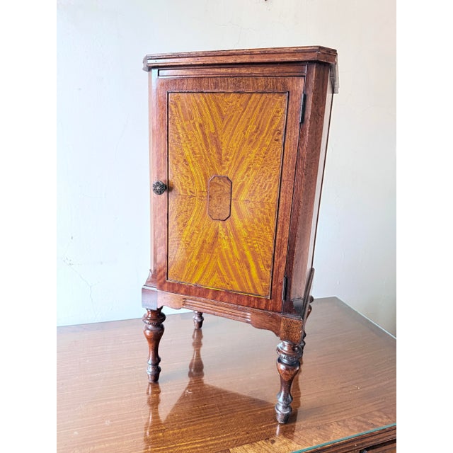 A refined example of American Federal style furniture from the late 19th century. This nightstand features a single door...