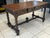 A very fine Louis XIII style desk in solid walnut from the early 19th century, intricately carved on all sides. It rests...
