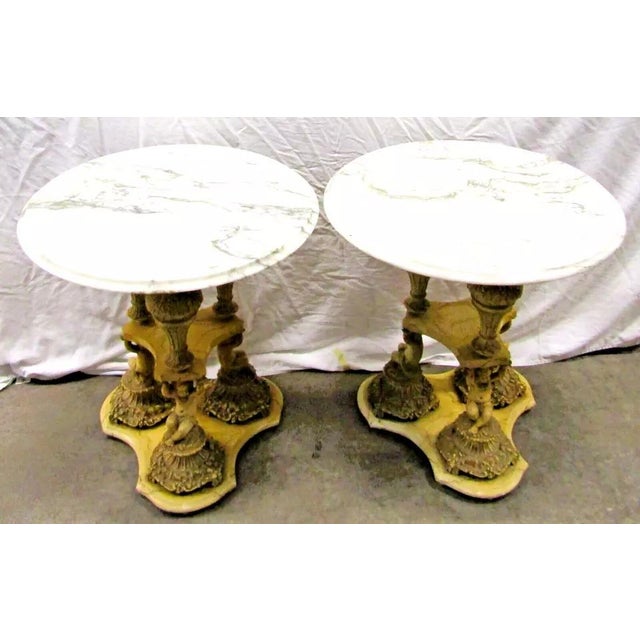 Pair of Italian Regency Florentine Marble Top Side Table with Triple Cherub Base Marble top. Cast metal base with marbled...