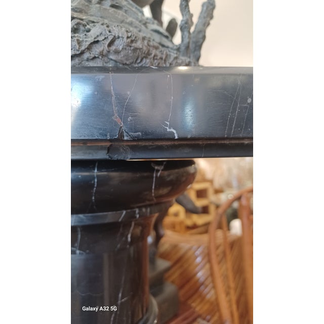 Vintage Hollywood Regency 2 piece marble pedestal. Pedestal is mostly black marble woth white steaks throughout