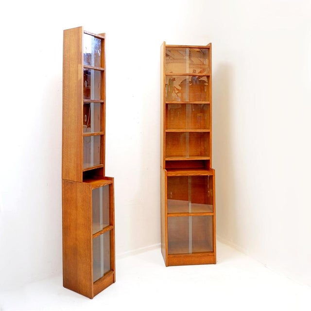 modernist and functionalist furniture - 1950s Measures : 28x32cm H:87+121 - TH:208cm A slimline bookcase on a small...