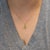 A natural sphene glows with green-gold brilliance and fire that rivals a diamond's, set within a halo of earth-mined...