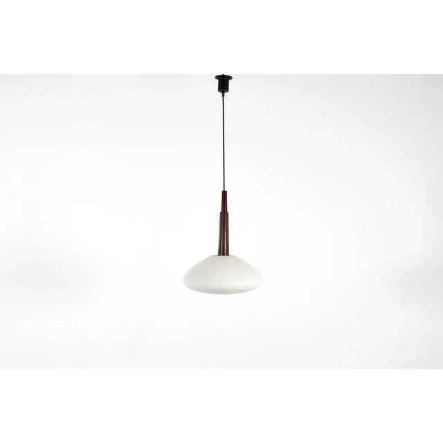 Very beautiful wooden suspension lamp with circular frosted glass globe, Italian production from the 1960s. Where...