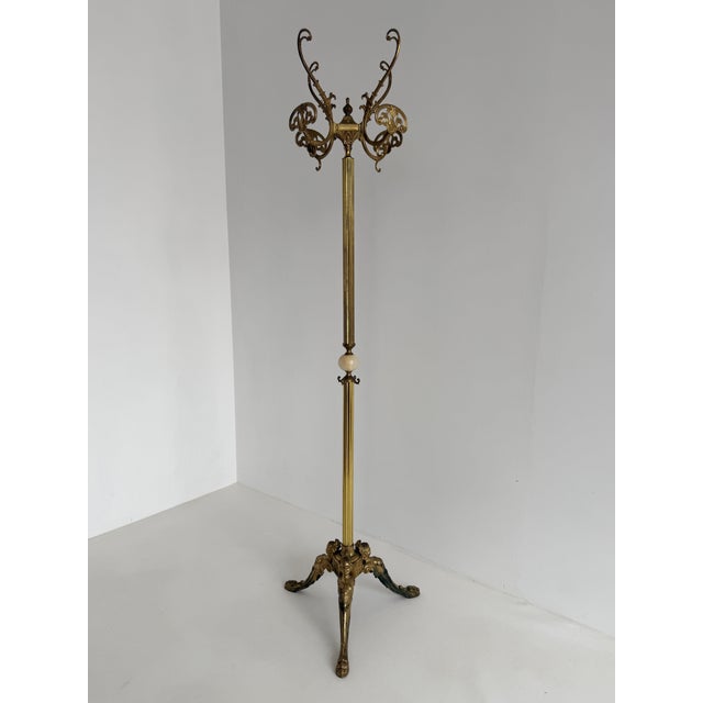 An elegant Italian hall tree crafted from brass and onyx, dating from the 1960s. This highly decorative piece features a...