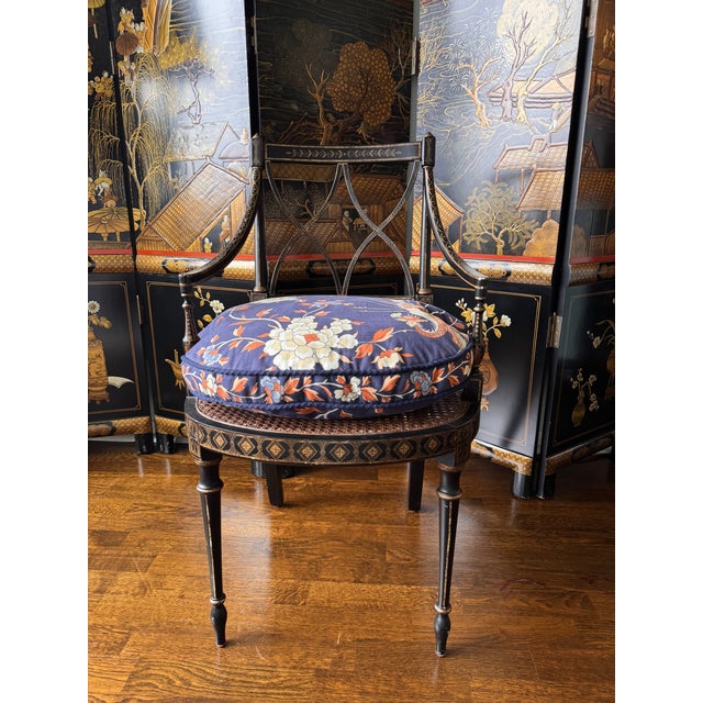 Vintage English Regency Caneback Chair painted in black and gold motiffs. Excellent structural condition, lightweight.....