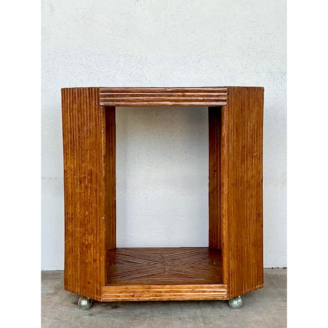 This striking vintage bar cart exemplifies the intricate craftsmanship of the late 20th-century organic modern movement....