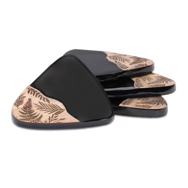 Elevate your tabletop style with this Floral Etched Wood Coaster Set. Featuring sleek black tones with natural wood grain...