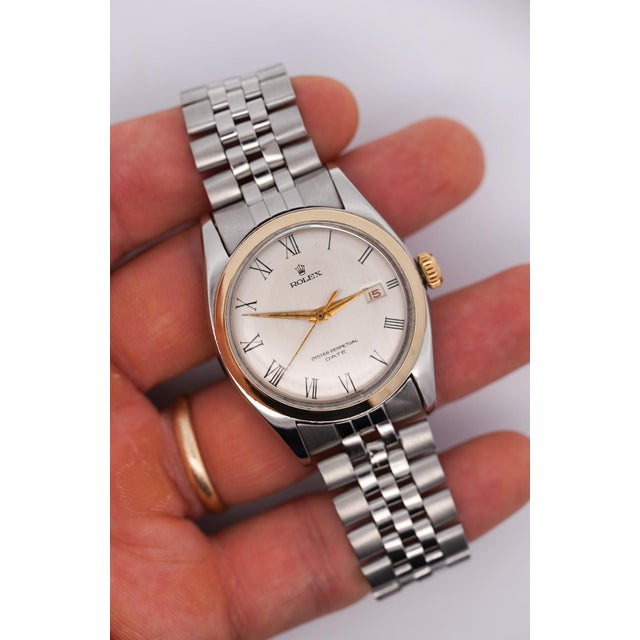 Vintage Rolex Oyster Perpetual Date men's and unisex watch in two-tone stainless steel and yellow gold, featuring a...