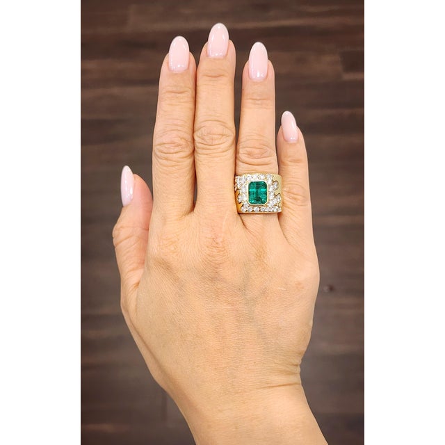 This exquisite 18k yellow gold ring showcases an approximate 3.50-carat natural emerald-cut emerald, exuding a rich green...