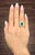 This exquisite 18k yellow gold ring showcases an approximate 3.50-carat natural emerald-cut emerald, exuding a rich green...