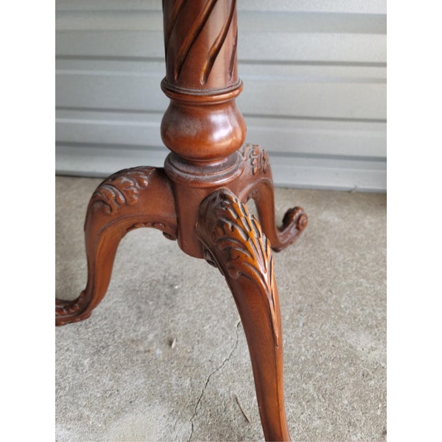 Intricate carved detailing on this rare, vintage, tiered table. Beautifully maintained and well cared for. Larger portion...