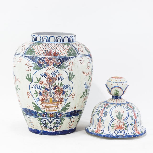 This beautiful vintage lidded vase or ginger jar features a traditional Delftware style but is decorated in a rare...