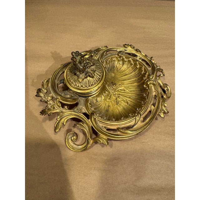 This is a beautiful antique inkwell & stand. It is made of brass with details of leaves etched into the metal. It is...