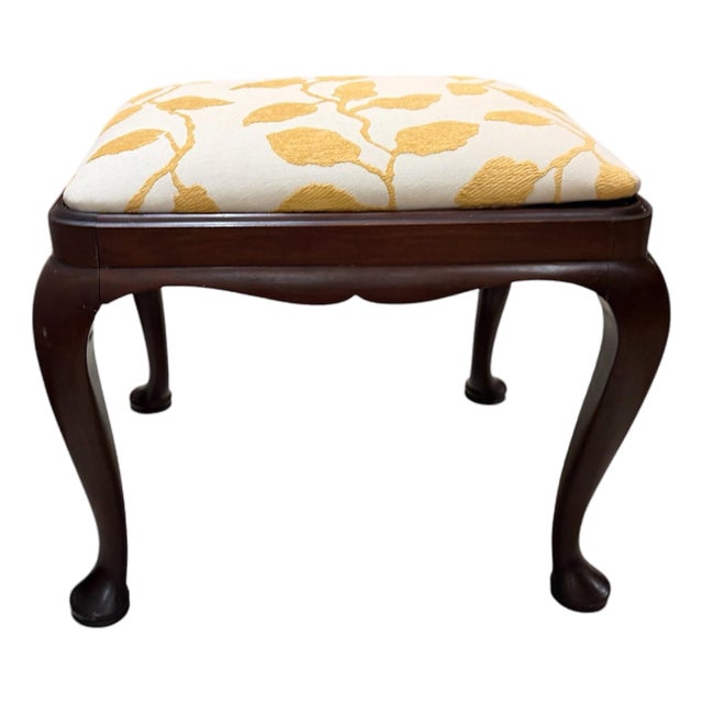 Vintage Queen Anne Style Footstool Features Dark Wood Cabriole Legs With Pad Feet and an Off-White Cushion Upholstered in a Yellow Leaf Pattern For Sale