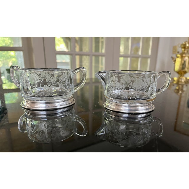Classic beautifully etched glass sugar and creamer. Duncan & Miller "First Love" design on sterling silver base. The...