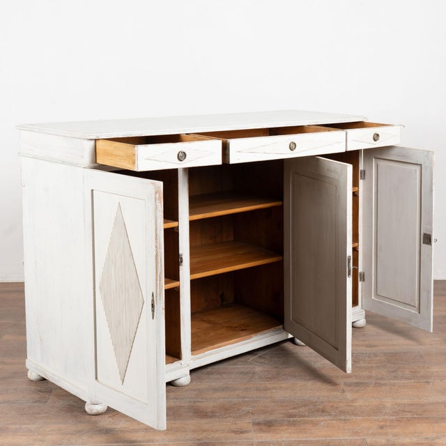 19th-century Swedish sideboard buffet crafted in pine with a three-drawer over three-door configuration. Each cabinet door...