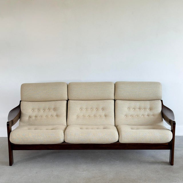 Beautiful Mid-Century Modern 3-seat sofa with a sculptural solid wood frame and button-tufted cushions. Upholstered in a...