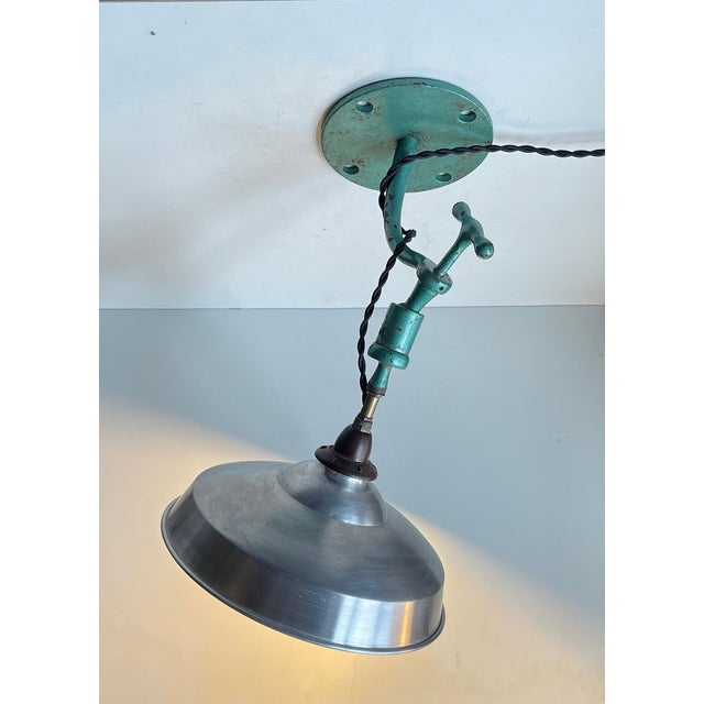Unique, versatile and fully adjustable wall, ceiling or table lamp executed in green hammer lacquer and featuring an...