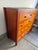 A beautifully crafted vintage chest by Baker Furniture, featuring dramatic book-matched burl wood drawer fronts, a warm...