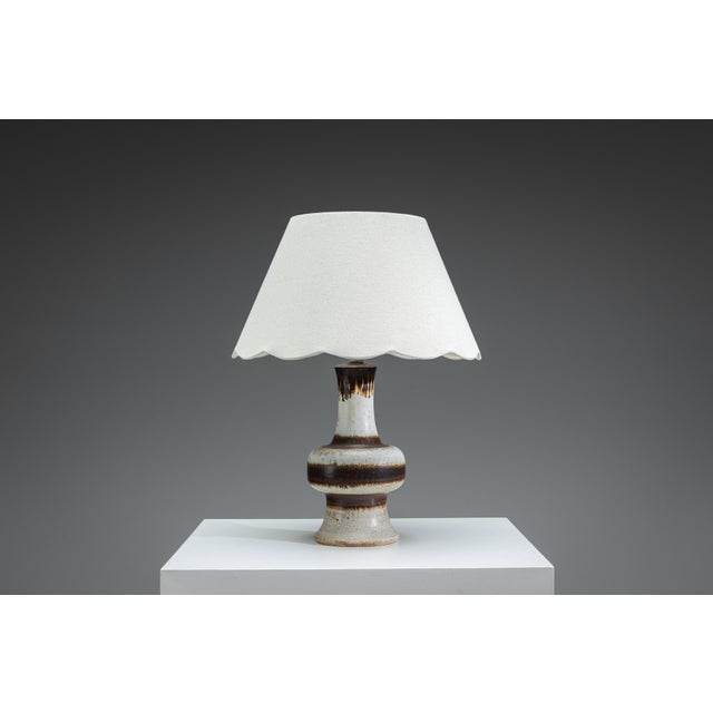 A beautifully sculptural vintage table lamp by Axella, embodying the timeless appeal of Danish Mid-Century design. The...