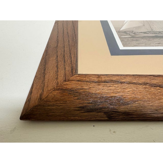 This is a late 20th century schooner print in the manner of Ralph Lauren. This schooner print is presented in a solid oak...