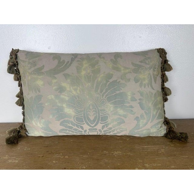 A refined decorative pillow featuring a softly rendered damask pattern in subtle, tonal hues that create a gentle sheen...