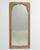 A circa 1920 French wall mirror influenced by the Art Nouveau movement, featuring a tall and elegant vertical format. The...