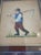 A charming vintage hand-stitched needlepoint depicting a folkloric peasant figure carrying a scythe, rendered in rich...