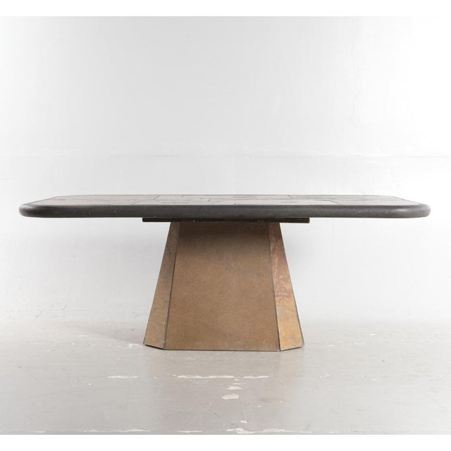 PAUL KINGMA. Rectangular coffee table in natural stone with inlaid brass and coins, octagonal leg base, signed, Denmark,...