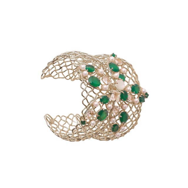 The Gianna Cuff, artfully crafted from semi-precious stones, showcases a distinctive net-style design with large flowers...