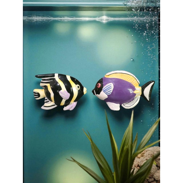 The Vintage Sakura Hand Painted Colorful Tropical Fish Salt & Pepper Shakers are a set of two ceramic shakers shaped like...