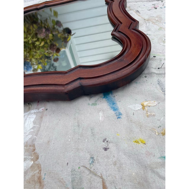 Timeless rounded mahogany wood mirror adds charm and warmth to any interior. This antique wall mirror featuring graceful...