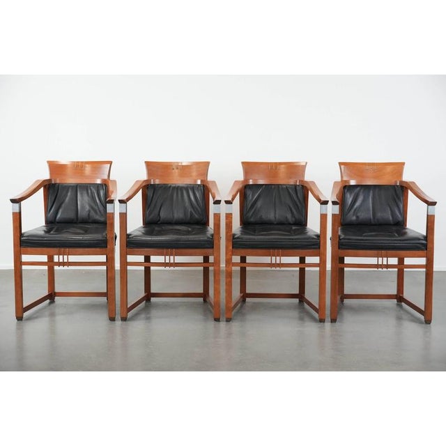 We are offering this set of 4 luxurious black leather Schuitema Art Deco dining chairs with armrests from the Decoforma...