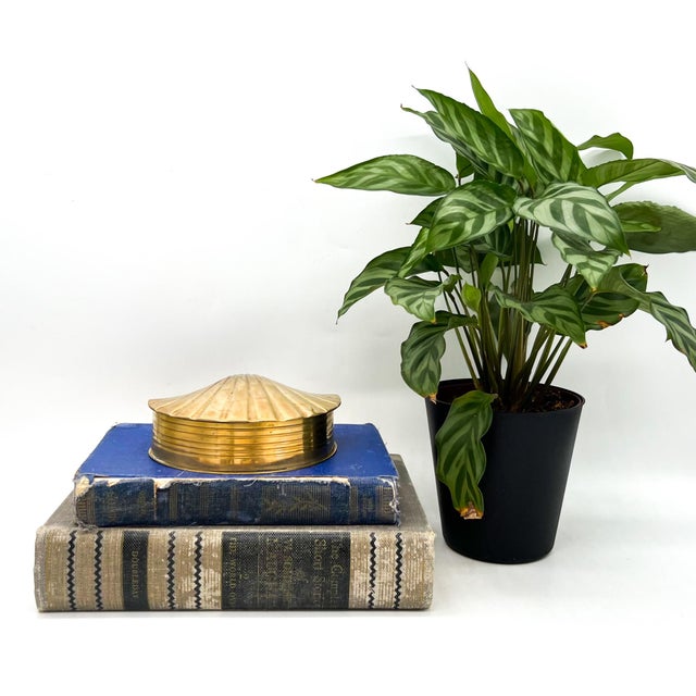 Gorgeous, mid to late 20th century brass box in a scallop shell form with fluted ridges that catch the light. Warm gold...
