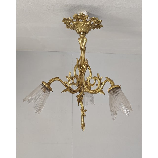 Stunning antique french chandelier in elegant louis xv bronze with beautiful acanthus leaf details and tulip glass shades....