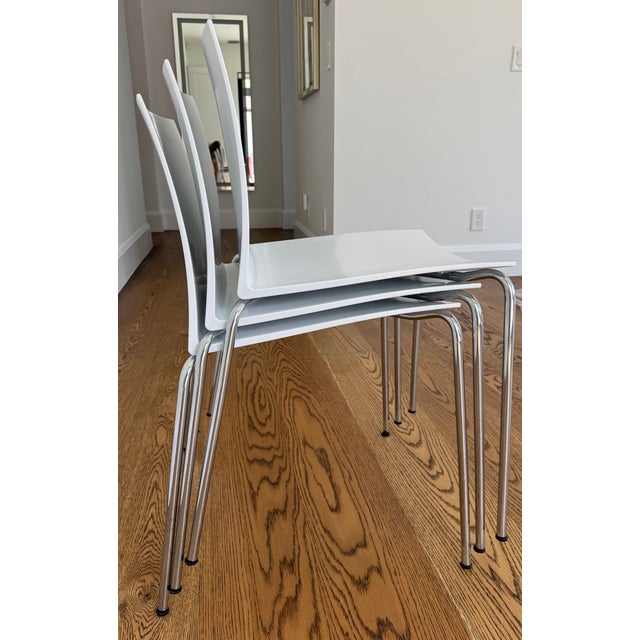 CB2 Slim Chair White and Chrome. Barely used. Excellent condition. 2016. Minimalist, curved square-cut back fit to form in...