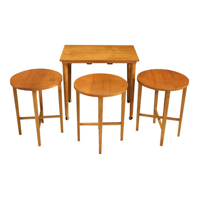Mid Century Modern table with 3 nesting tables, circa 1960-70s, Danish. Design attributed to Poul Hundevad. A rectangular...