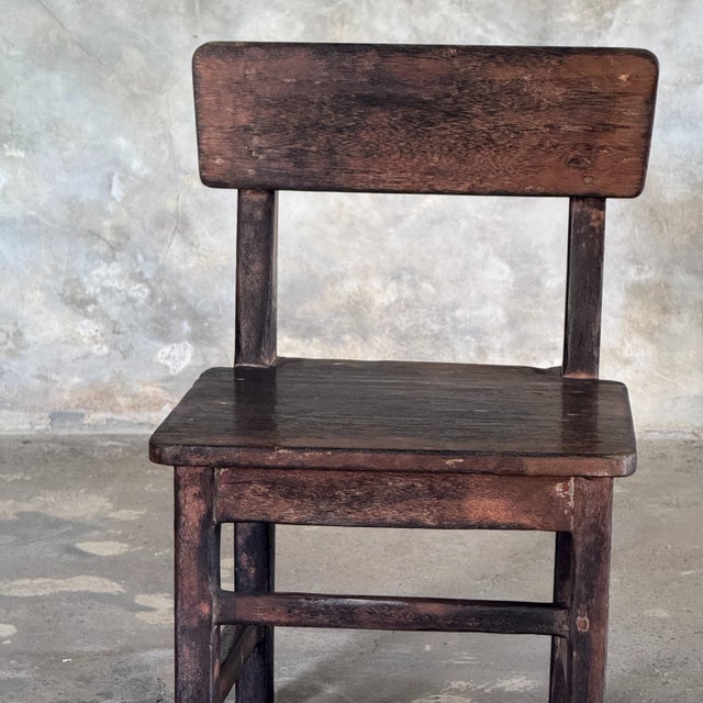 Small antique Indonesian teak child's chair. Dimensions: Width: 35cm; Total height: 55cm; Seat height: 30cm; Depth: 32cm....