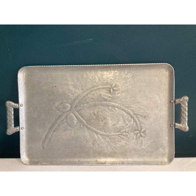 A vintage Everlast forged aluminum tray with embossed pinecone and branch design, hammered handles, and a sturdy...