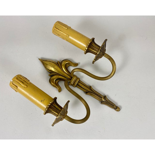 A single bronze sconce with stunning hand-made decor. Ornate fleur-de-lis (lily flower) motif detailing on top. Floral...