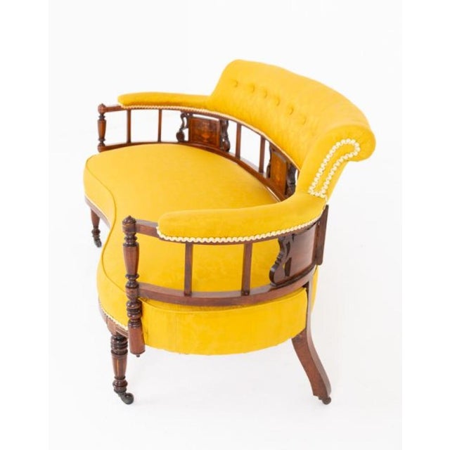 An elegant mahogany inlaid settee of refined proportions and excellent craftsmanship. This graceful shaped settee is...