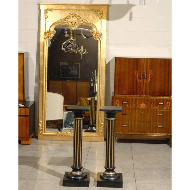 Pair of antique Empire Neoclassical Swedish pedestals painted ebony with gold accents.