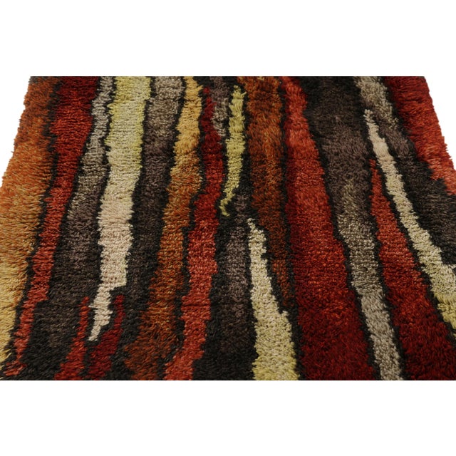 Hand-knotted in lush, high-pile wool in Sweden circa 1960-1970, this 4x6 vintage Swedish Rya rug is a bold new addition to...