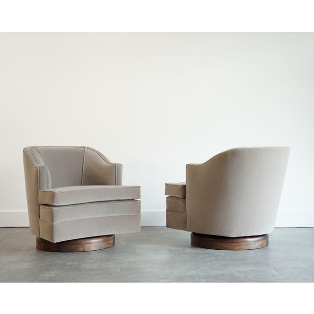 A refined pair of 1950s lounge chairs with elegant, sculptural lines reminiscent of Edward Wormley for Dunbar. Expertly...