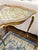 This side table is sturdy yet light. The frame is painted gold, and the top is covered in beautiful Florentine ornamentation.