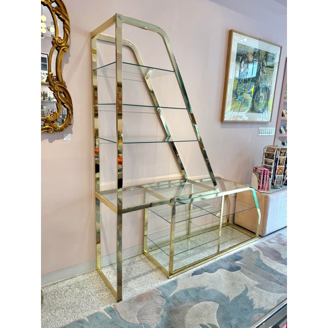 A fabulous 1983 polished brass and glass adjustable two part etagere by Design Institute of America. DIA is renowned for...