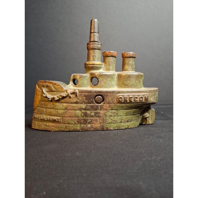 Offered is an authentic 19th-century cast iron still bank depicting the famous Spanish-American War naval vessel...