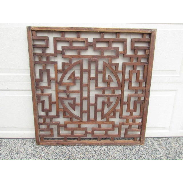 Chinese lattice wood carved wall panel or window screen, c.1930’s Made from sections of wood arranged in a geometric...